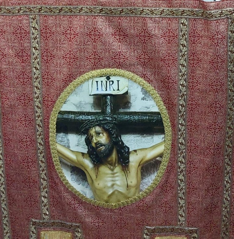 Detalle del estandarte restaurado de la Hermandad del Cristo de la Expiación con la imagen del INRI, fotografía realizada por Ikonox.